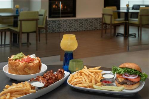 a table with two plates of food and french fries at Residence Inn Seattle Bellevue Downtown in Bellevue