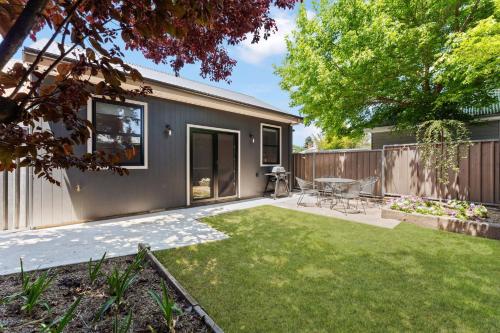 a backyard with a house with a lawn at Charming Studio for Two in the Heart of Bathurst in Bathurst