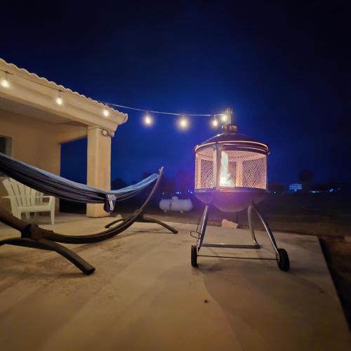 a lantern sitting on a chair in front of a house at night at The Fieldhouse in Blythe