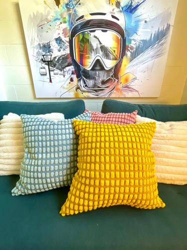 a helmet sitting on top of a couch with pillows at White Rabbit Mountain Guest House in Mount Beauty