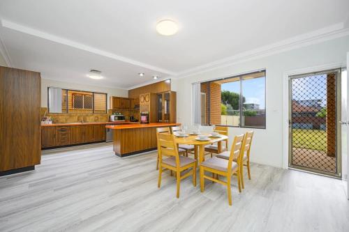 a kitchen and dining room with a table and chairs at Liverpool Oasis 5BR Home for Groups and Families in Liverpool