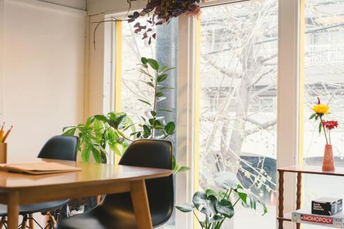 an office with a table and chairs and a window at Guest House Waya in Sapporo