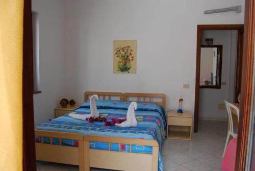 a bedroom with a bed with a doll on it at Baia Unci in Canneto