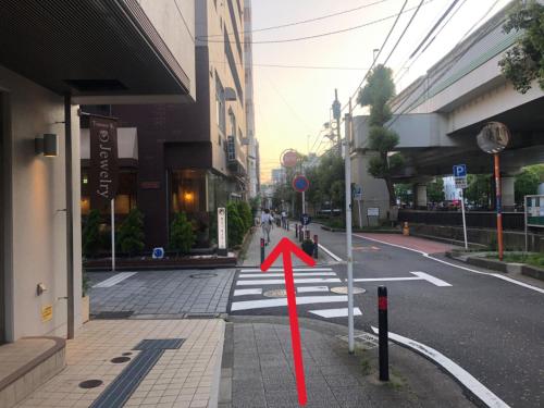 an empty street with a red arrow on a crosswalk at YOKOHAMA STAY PREMIER in Yokohama