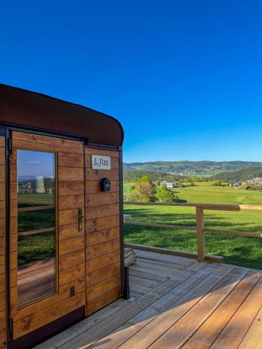 a wooden outhouse on a deck with a view at Le petit in Úpice