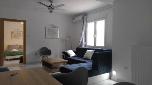 a living room with a couch and a table at Family 2bdr 100sqm Airport 10min and Free Parking in Thessaloniki