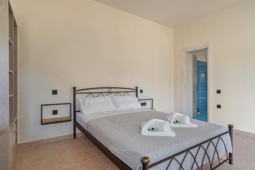 a bedroom with a bed with two towels on it at Panagis Apartments in Argostoli