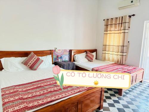 a bedroom with two beds and a sign that says go to living chi at Cô Tô Lương Chi in Quang Ninh