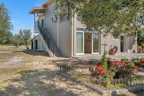 a house with flowers in front of it at Panagis Apartments in Argostoli