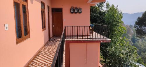 a balcony of a house with a view at Sejal Homestay in Shimla