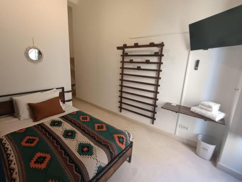 a bedroom with a bed with a comforter on it at B&B via Cattedrale 5 in Bitonto