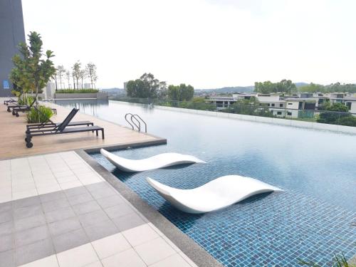 a swimming pool with white sculptures in the water at TR12 tulip elmina 5pax Big cinema movie 1 free parking in Shah Alam