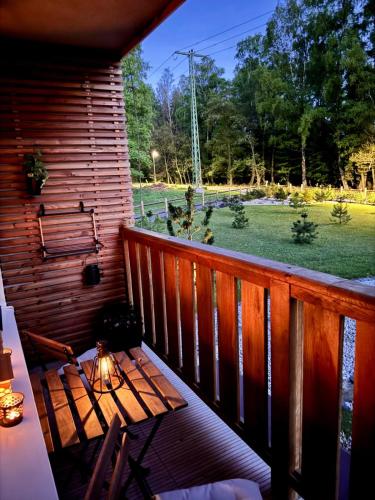 a balcony with a table and a view of a yard at Apartmány Hřensko in Hřensko