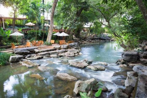 a pool of water with rocks in a river at khaoyai lumtakong hotel in Mu Si