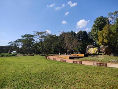 a park with a bench in the middle of a field at khaoyai lumtakong hotel in Mu Si