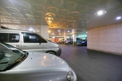 a parking lot with cars parked in a parking garage at Luxury Motel Daejeon in Daejeon