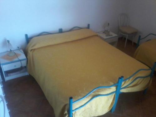 a bedroom with a large bed with a yellow blanket at B&B Domo De Pedra in Tottubella