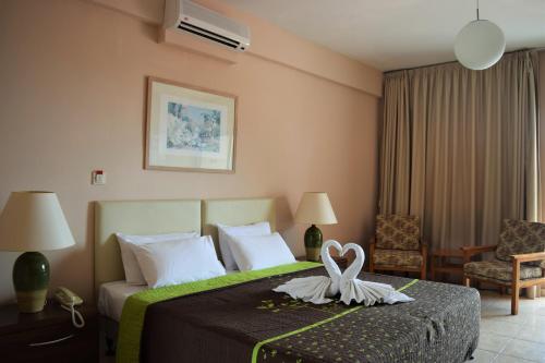 a hotel room with a bed with a heart on it at Anna Hotel Apartments in Paphos City