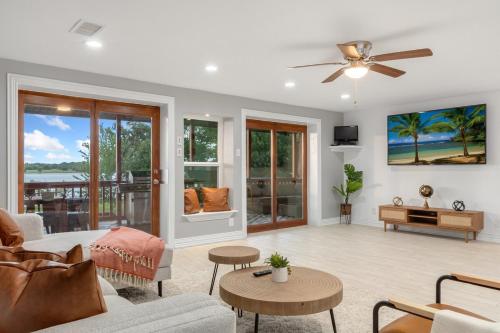 a living room with a couch and a ceiling fan at Lakefront Retreat Sleeps 15 Starlink Internet in Mabank
