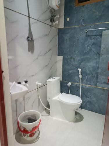 a bathroom with a toilet and a sink at Little Hearts recidency in Āvadi