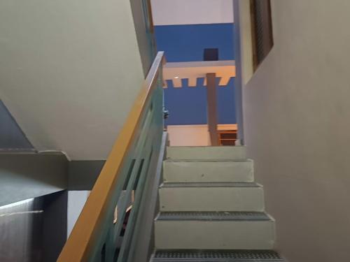 a stairway in a building with a blue wall at Little Hearts recidency in Āvadi