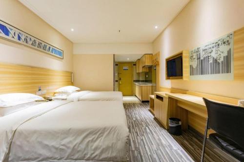 a hotel room with two beds and a desk at City Comfort Inn Wuhan Hankou Railway Station West Square in Wuhan