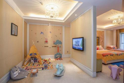 a room with a bedroom with a bed and a tv at Fortune International Hotel in Xiawutun