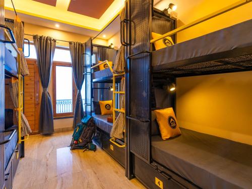 a group of bunk beds in a room at The Hosteller Chakrata in Chakrāta