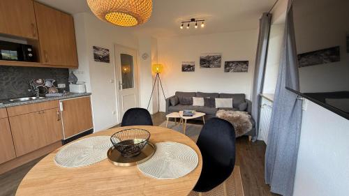 a kitchen and a table in a living room at Haus Anna in Fischen