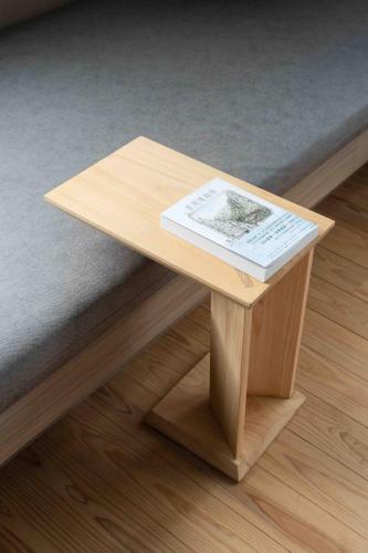 a wooden coffee table with a book on it at OR Inn Beipu in Beipu