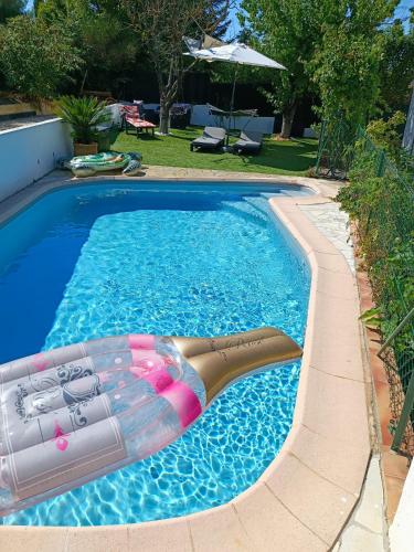 une piscine avec un radeau au au milieu de celle-ci dans l'établissement L'escapade d'Allauch, à Allauch