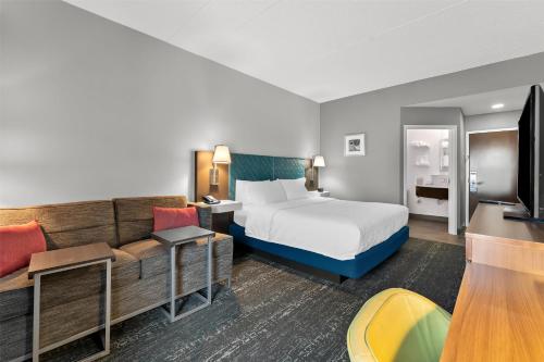 a hotel room with a bed and a couch at Hampton Inn & Suites Newtown in Yardley