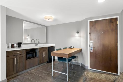 a kitchen with a wooden table and a sink at Hampton Inn & Suites Newtown in Yardley