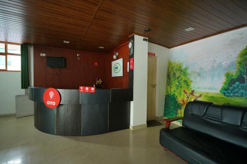 a lobby with a waiting area in a building at Hotel O Greenland in Meppādi