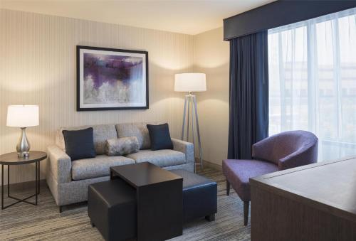 a living room with a couch and a chair at Homewood Suites by Hilton Needham Boston in Needham