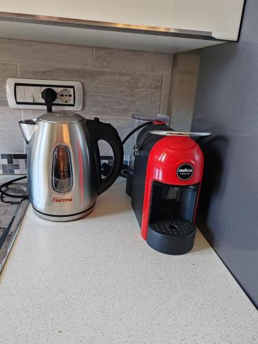 a coffee maker and a toaster sitting on a counter at Relax & Fun home in Sìnnai
