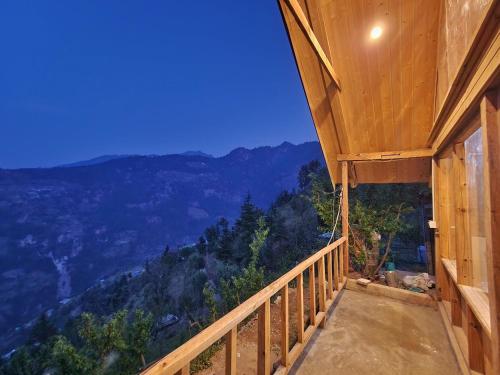 a room with a balcony with a view of the mountains at Mountain A Frame Stay Sainj in Sainj