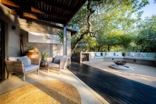 an outdoor patio with chairs and a fire pit at Rafiki Bush Lodge in Hoedspruit