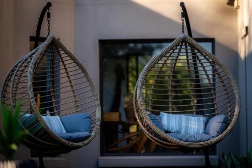 two hanging baskets with pillows in a room at Rafiki Bush Lodge in Hoedspruit