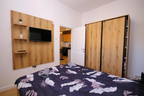 a bedroom with a bed and a large wooden closet at White Diamond in Palić
