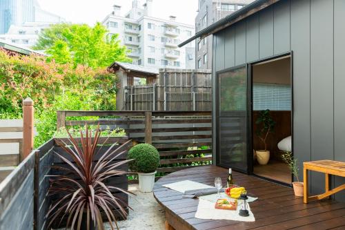 a patio with a wooden table on a balcony at HOTEL RIN TOKYO - Private Townhouse - in Tokyo