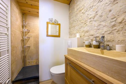 une salle de bain avec un lavabo, des toilettes et une douche dans l'établissement Ancien chai réthais restauré en 2020, à Sainte-Marie de Ré