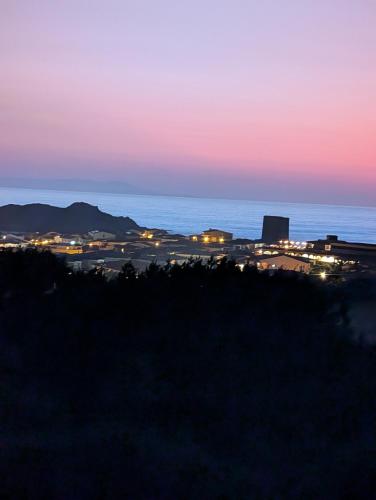 a view of a city at night at Appartamento isola rossa vista mare in Isola Rossa