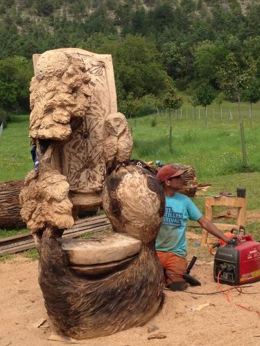 a man working on a statue of a toilet at Ferienwohnung Dietlinde in Bad Blankenburg