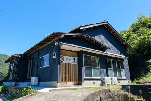 a blue house with a brown door at Private inn Mei Vacation Rental MEI - Vacation STAY 57858v in Ino