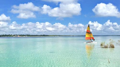 a sail boat in the middle of a large body of water at Casa Lamat in Bacalar