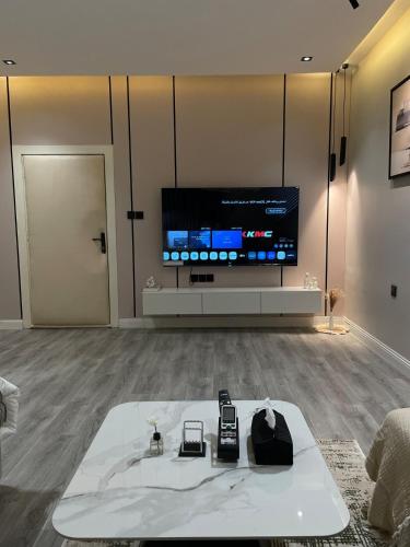 a living room with a tv and two cell phones on a table at Studio in the resort Smart Entry in Quai