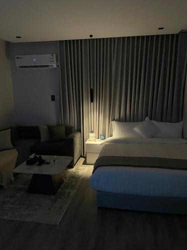 a hotel room with a bed and a couch at Studio in the resort Smart Entry in Quai