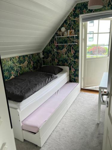 a bed in a room with a green wall at Central home in Oslo! in Oslo