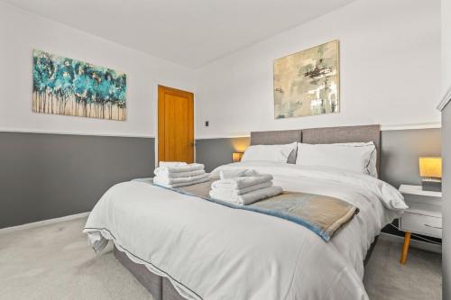 a bedroom with a large bed with towels on it at The Bishopsworth House in Bristol